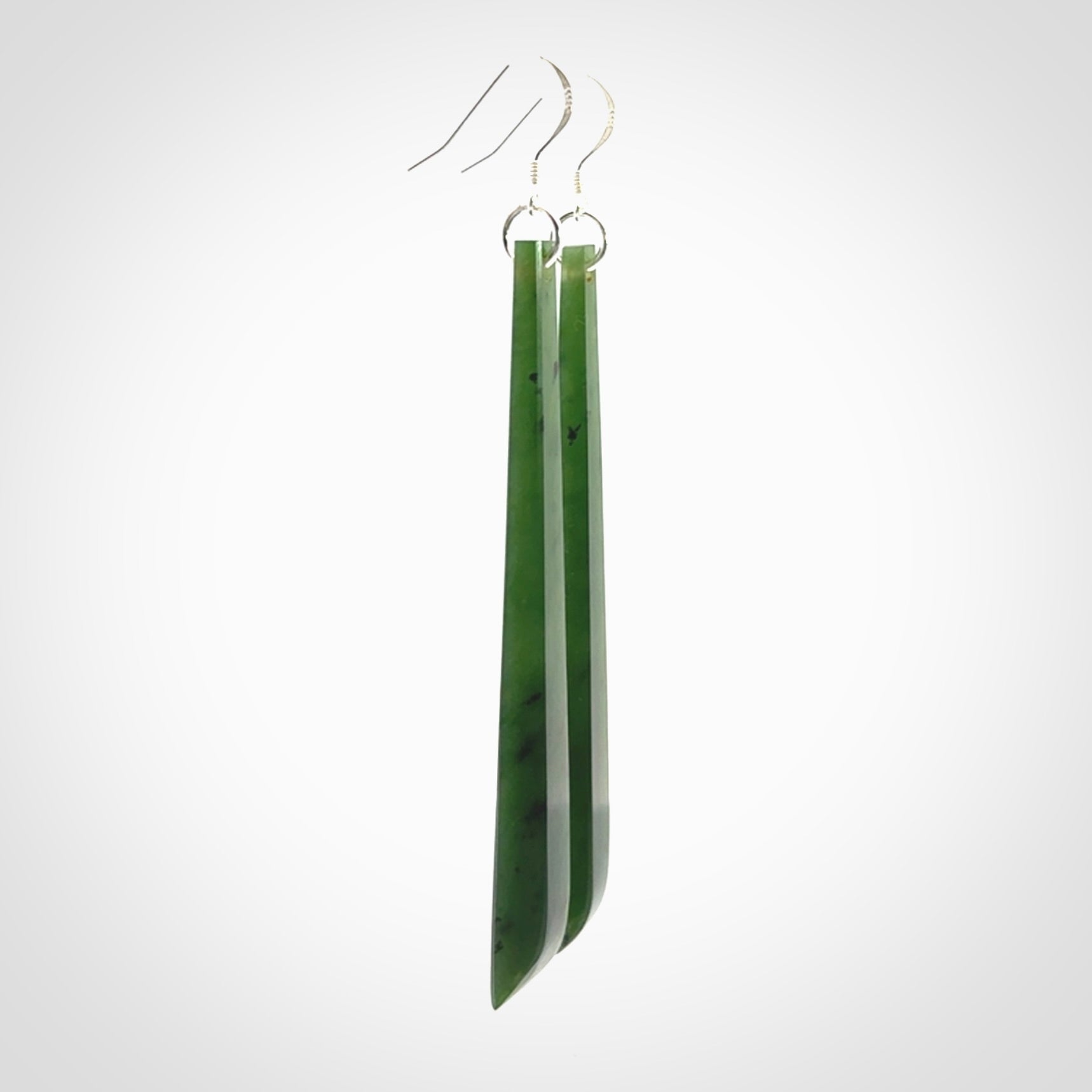 These are stunning large sized drop flower jade earrings carved in New Zealand. It is carved from a beautiful green piece of New Zealand Flower Jade and with Sterling Silver hooks and findings.