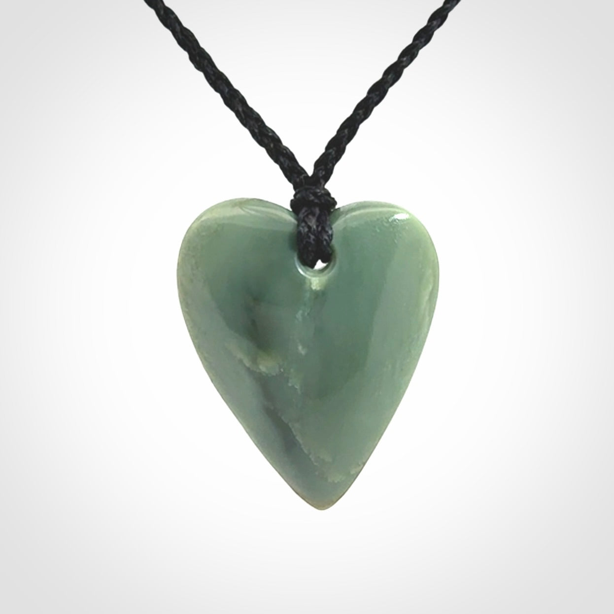 A hand carved small heart pendant made from New Zealand Inanga jade.