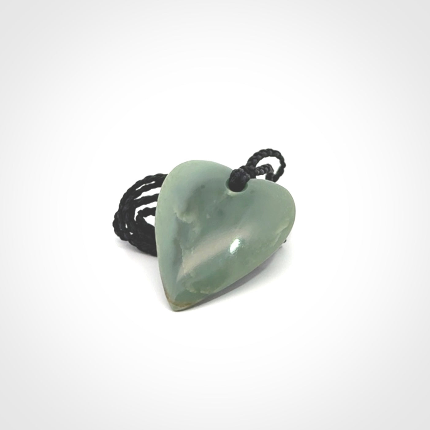A hand carved small heart pendant made from New Zealand Inanga jade.