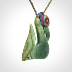 This picture shows a contemporary manaia with hook pendant. The cord colour is khaki and it is length adjustable. This is a very beautiful piece of art to wear.