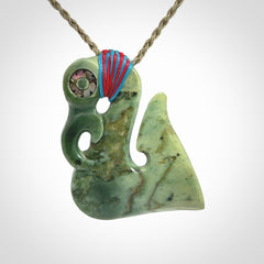 This picture shows a contemporary manaia with hook pendant. The cord colour is khaki and it is length adjustable. This is a very beautiful piece of art to wear.