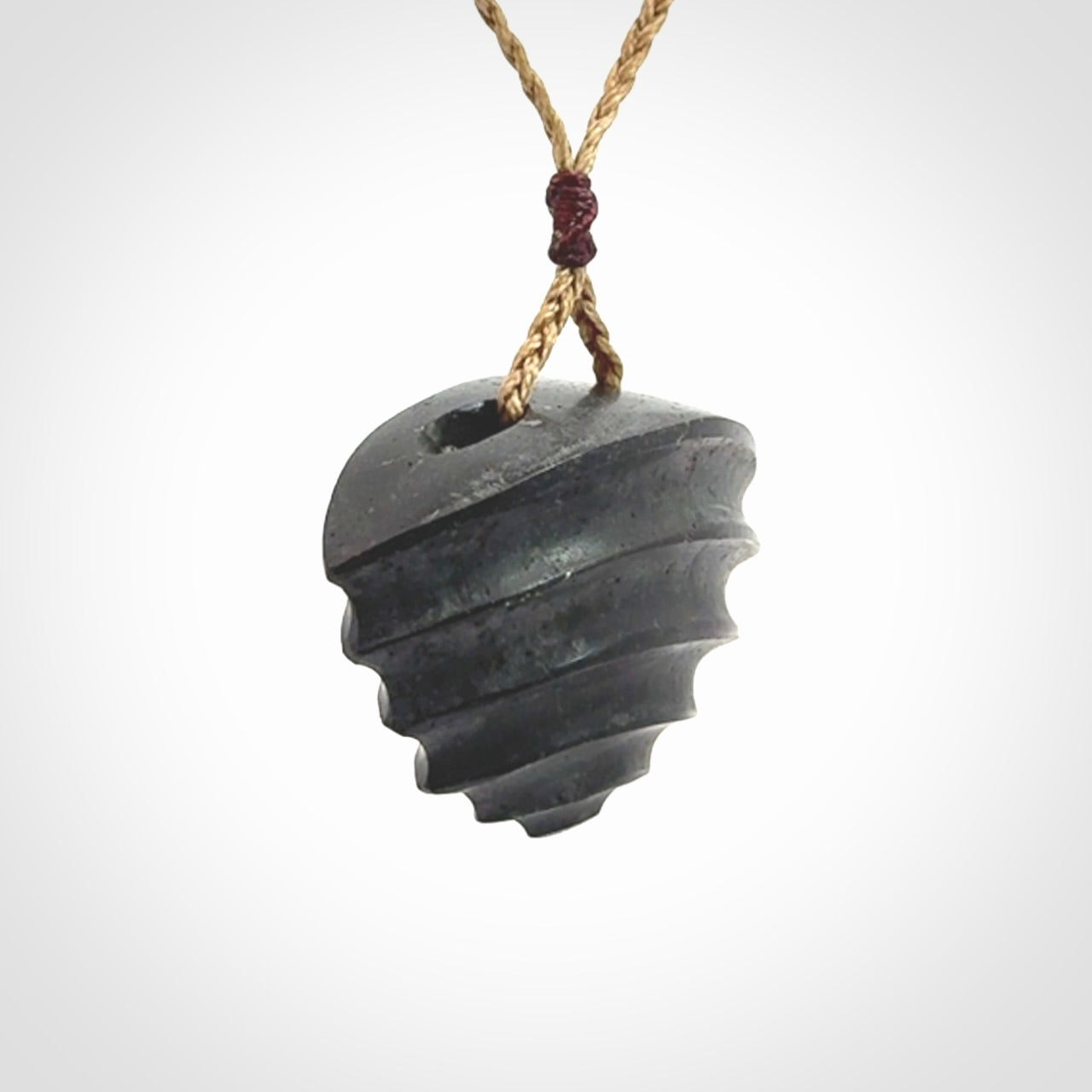 This picture shows a medium sized Onewa Stone contemporary drop pendant. A hand made unique and contemporary necklace hand carved here in New Zealand.