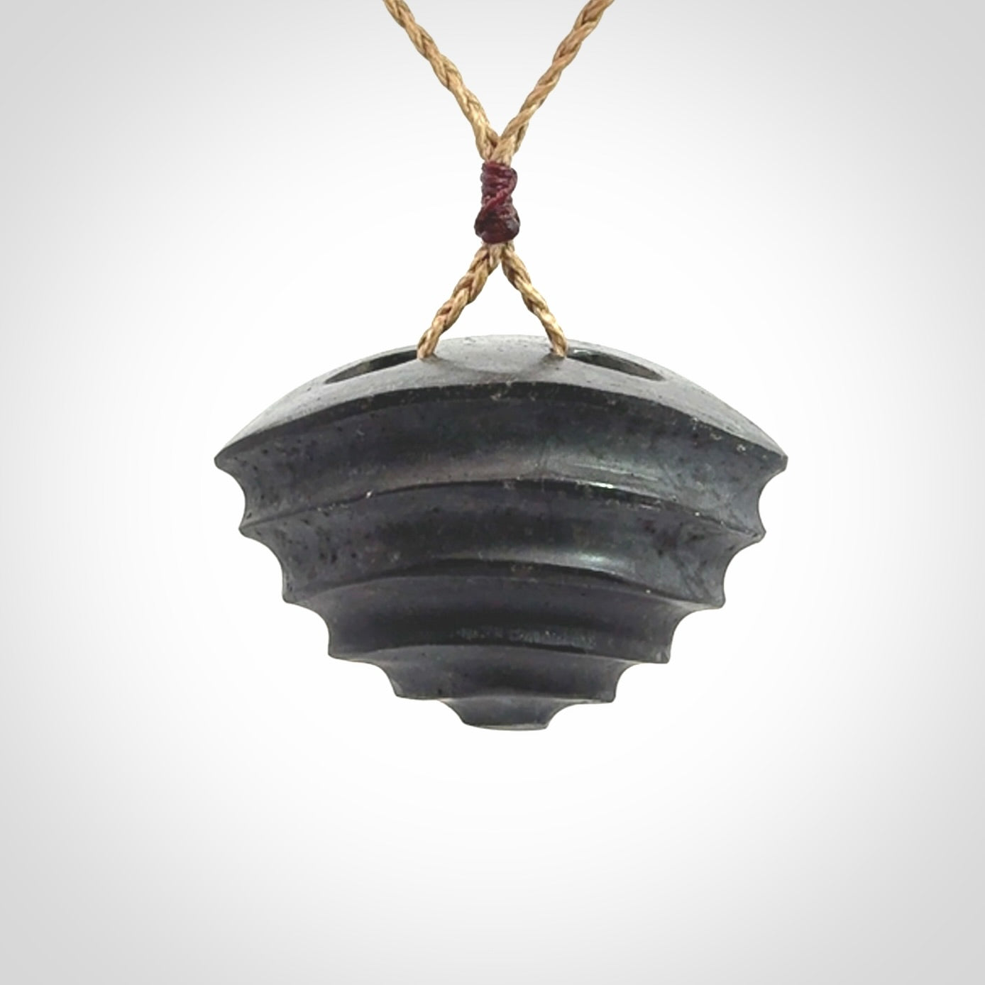 This picture shows a medium sized Onewa Stone contemporary drop pendant. A hand made unique and contemporary necklace hand carved here in New Zealand.