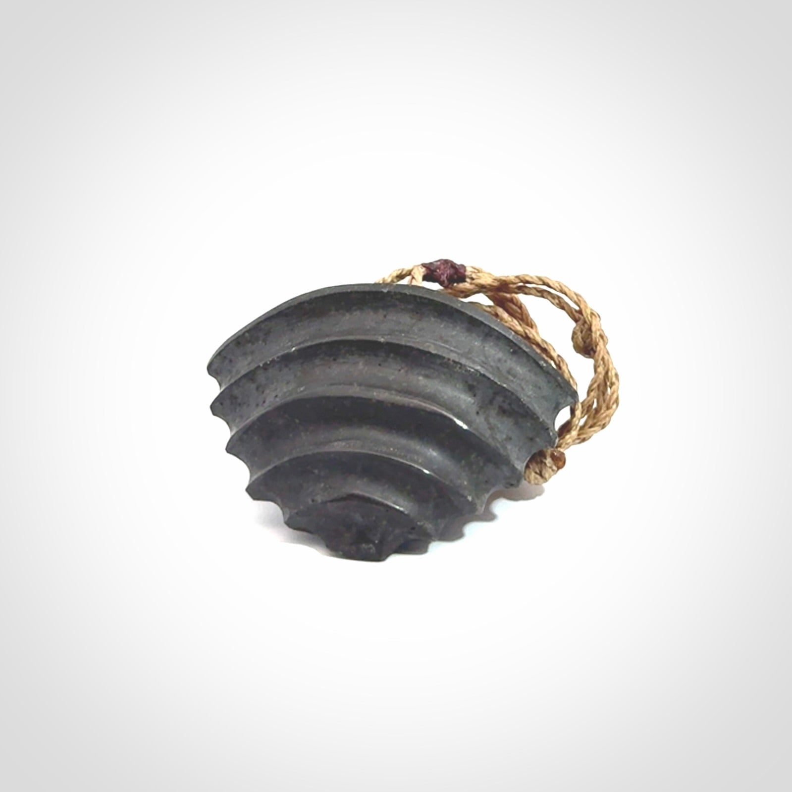 This picture shows a medium sized Onewa Stone contemporary drop pendant. A hand made unique and contemporary necklace hand carved here in New Zealand.