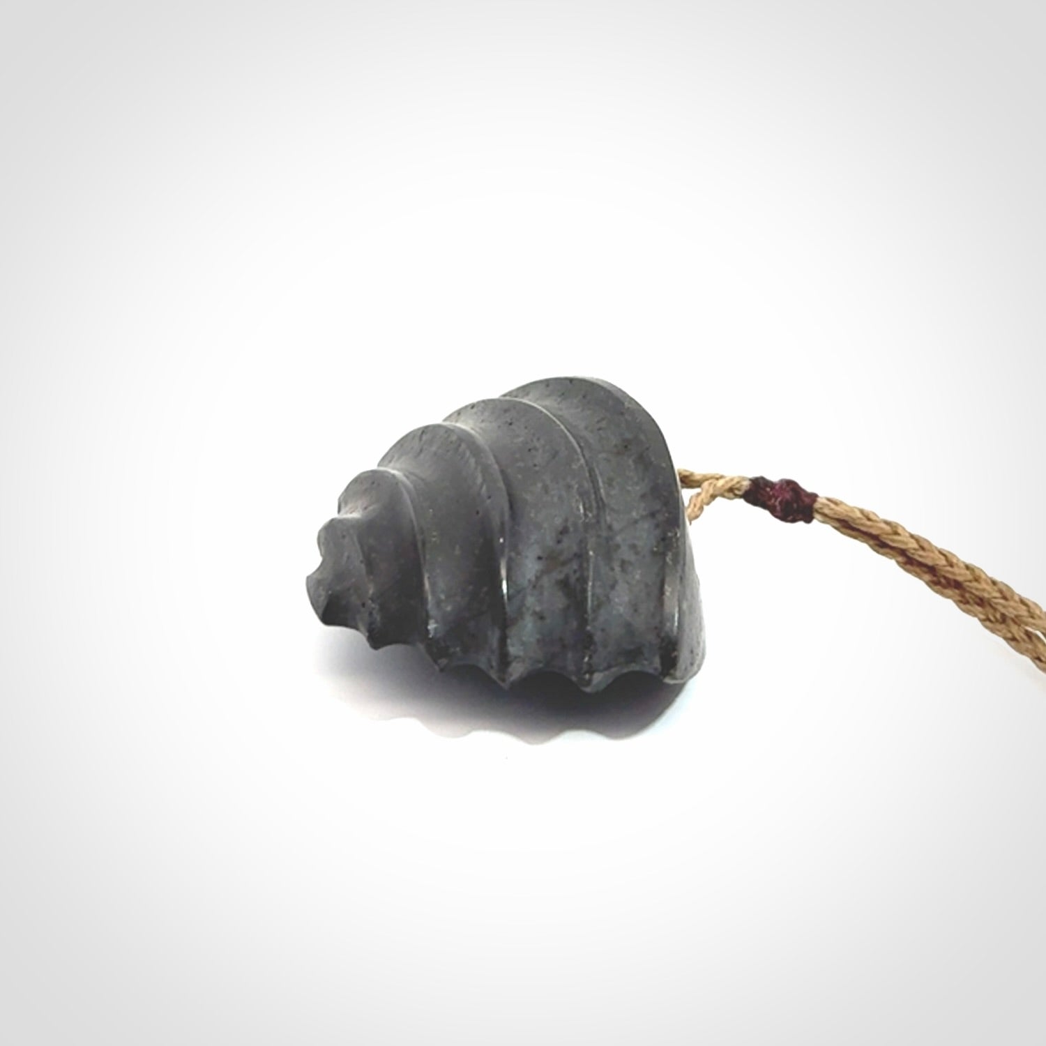 This picture shows a medium sized Onewa Stone contemporary drop pendant. A hand made unique and contemporary necklace hand carved here in New Zealand.