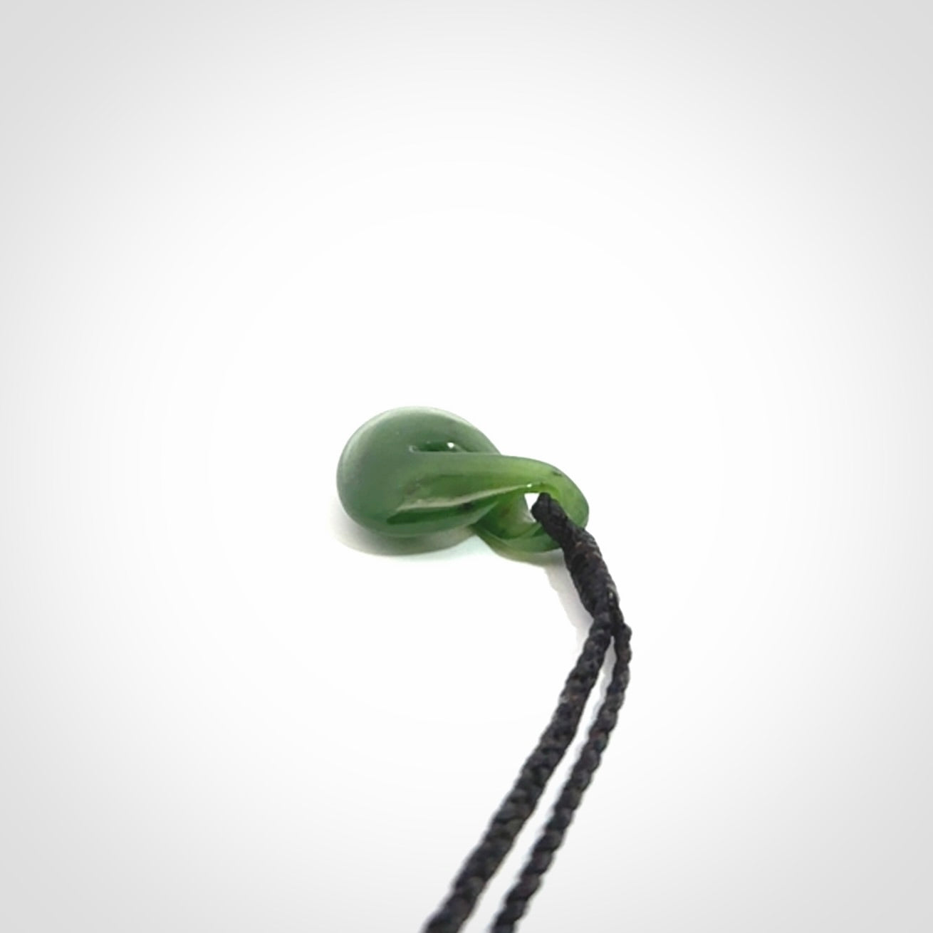 Single twist pendant. Hand carved from rare New Zealand jade this is a beautiful small pounamu pendant. The cord is length adjustable.