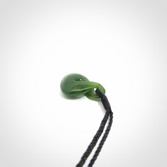 Single twist pendant. Hand carved from rare New Zealand jade this is a beautiful small pounamu pendant. The cord is length adjustable.