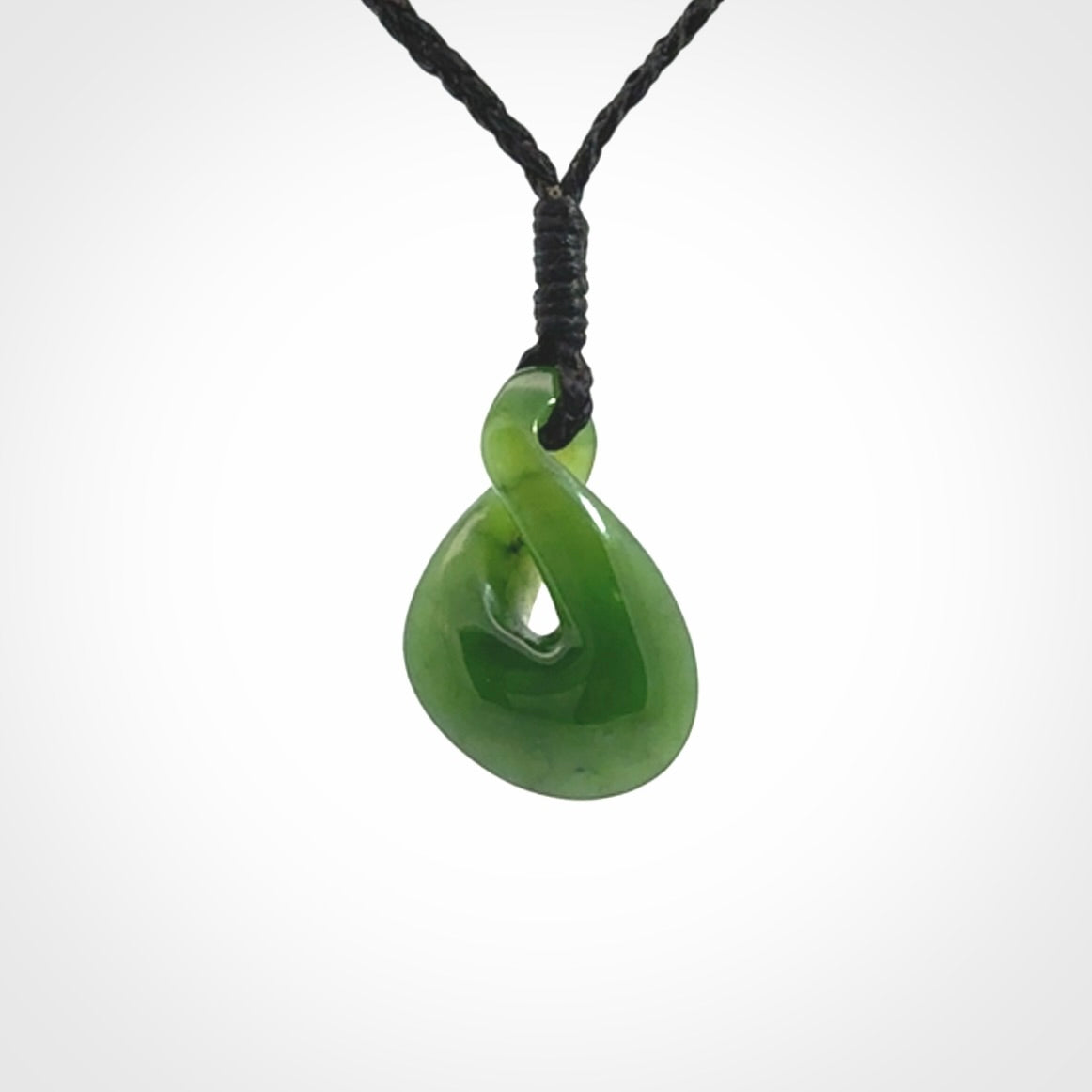 Single twist pendant. Hand carved from rare New Zealand jade this is a beautiful small pounamu pendant. The cord is length adjustable.