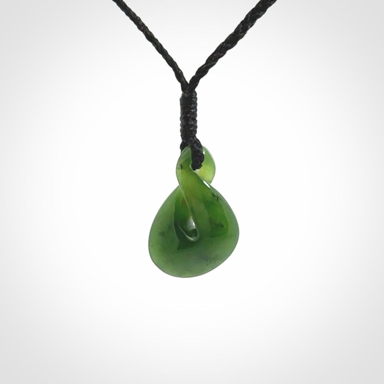 Single twist pendant. Hand carved from rare New Zealand jade this is a beautiful small pounamu pendant. The cord is length adjustable.