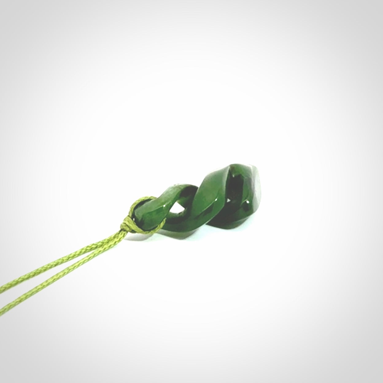Hand carved small sized, New Zealand jade double twist pendant.
