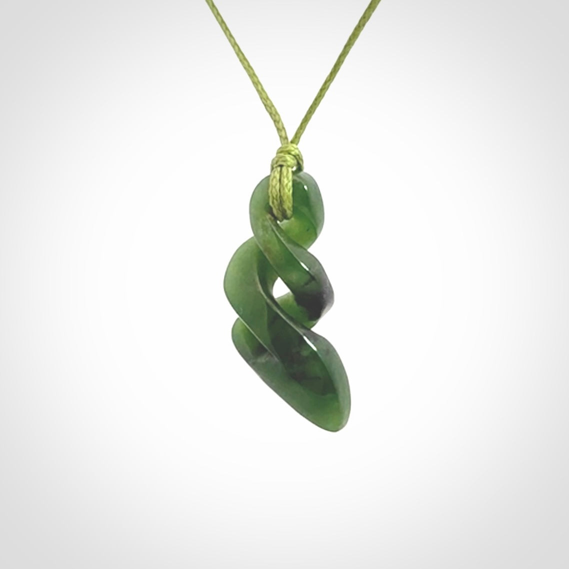 Hand carved small sized, New Zealand jade double twist pendant.