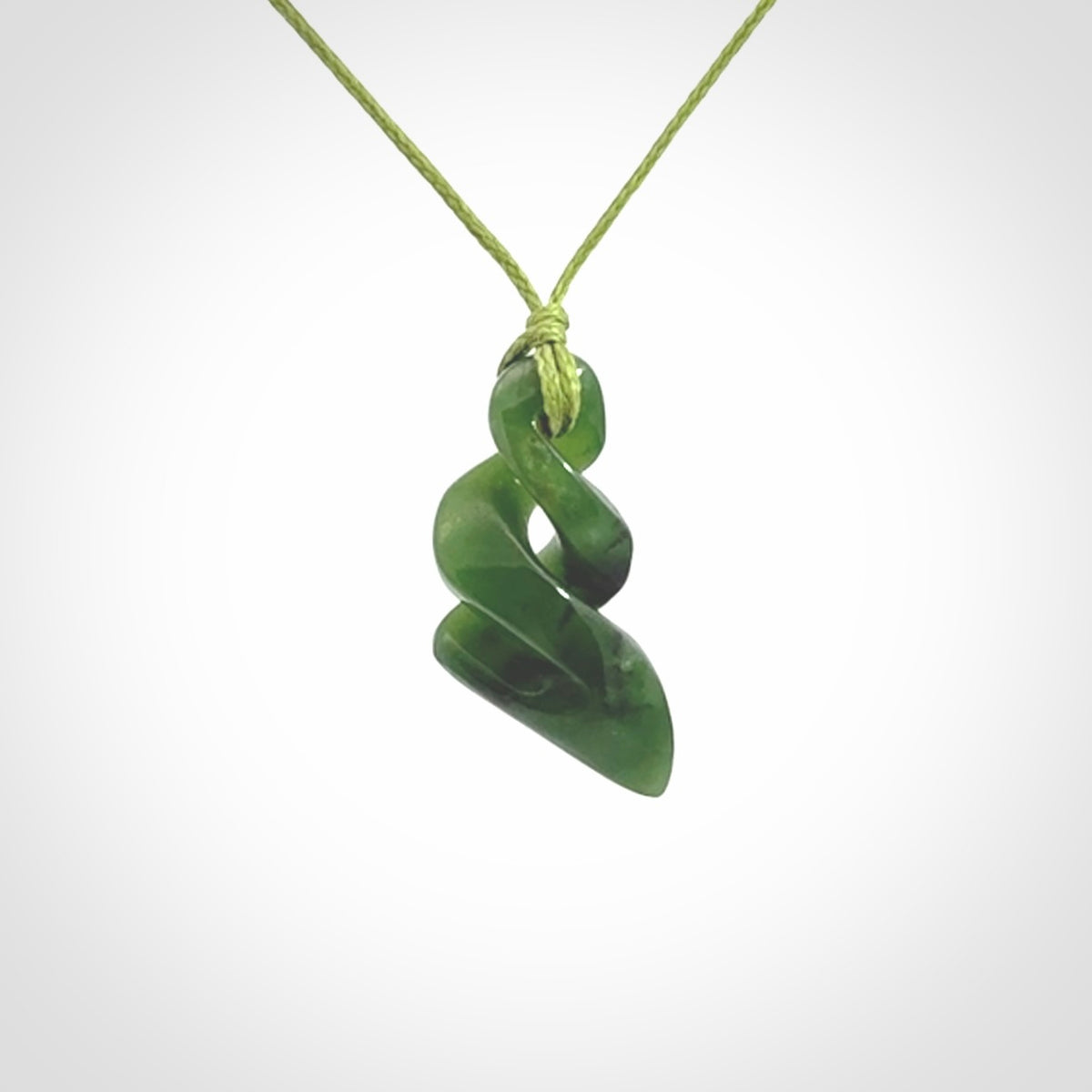 Hand carved small sized, New Zealand jade double twist pendant.