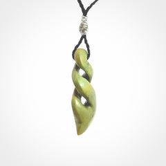 Double twist pendant. Hand carved from rare New Zealand flower jade this is a beautiful pounamu pendant. The cord is hand plaited in a black colour and is length adjustable. It has a floret in silver. It is a delicate and very beautiful greenstone pendant. For sale online by NZ Pacific.