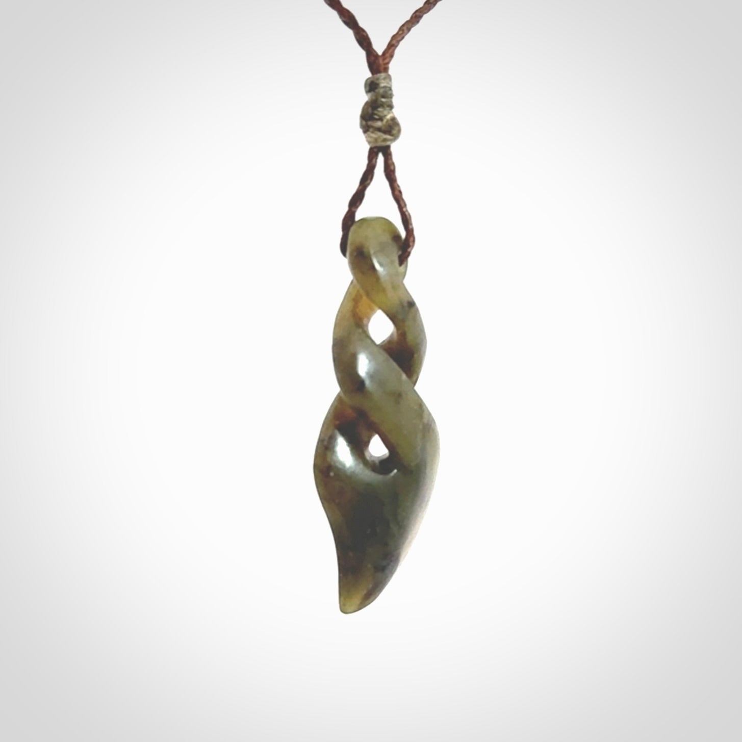 Hand carved small sized, New Zealand jade double twist pendant.