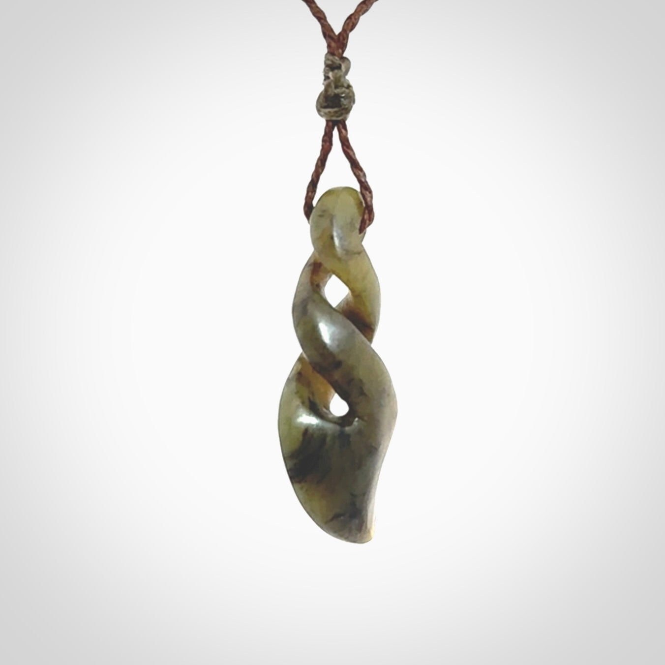 Hand carved small sized, New Zealand jade double twist pendant.