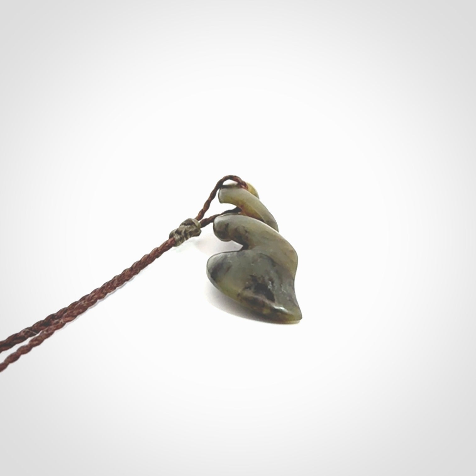 Hand carved small sized, New Zealand jade double twist pendant.