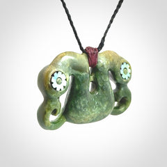 Jade Pekapeka, double manaia, pendant hand made here in New Zealand. The cord is black is adjustable. Unique necklace for men and women. Pekapeka necklace hand made from New Zealand Jade with Pāua Shell and Mother of Pearl eyes.