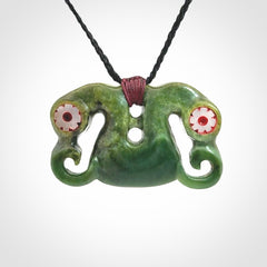Jade Pekapeka, double manaia, pendant hand made here in New Zealand. The cord is black is adjustable. Unique necklace for men and women. Pekapeka necklace hand made from New Zealand Jade with Pāua Shell and Mother of Pearl eyes.
