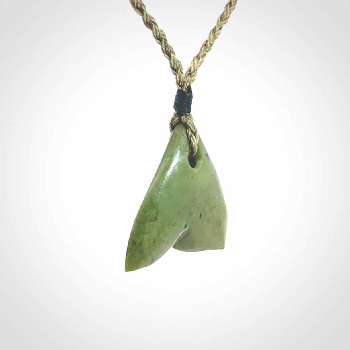 Hand carved small New Zealand Jade whale tail pendant.