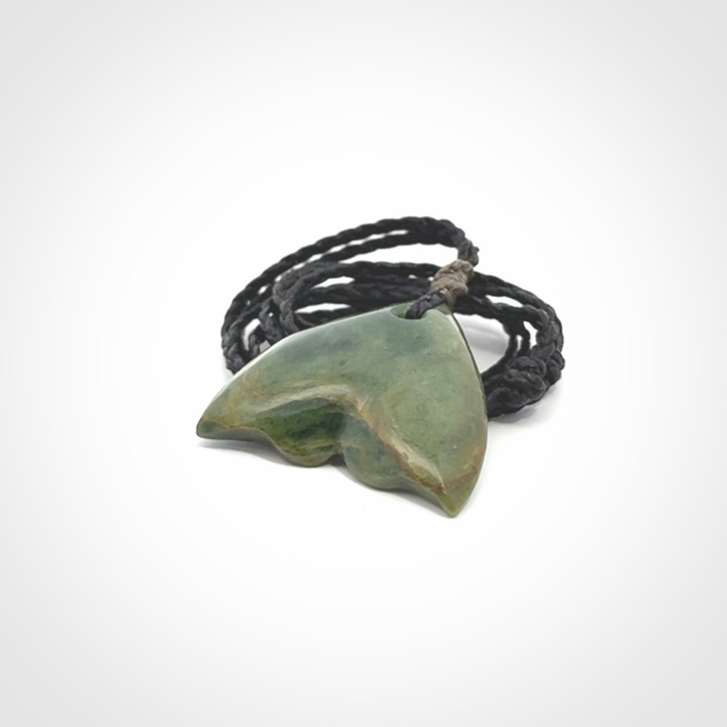 Hand carved small New Zealand Jade whale tail pendant.