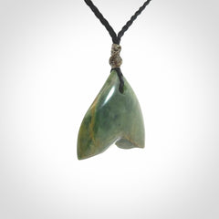 Hand carved small New Zealand Jade whale tail pendant.