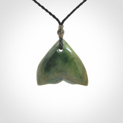 Hand carved small New Zealand Jade whale tail pendant.