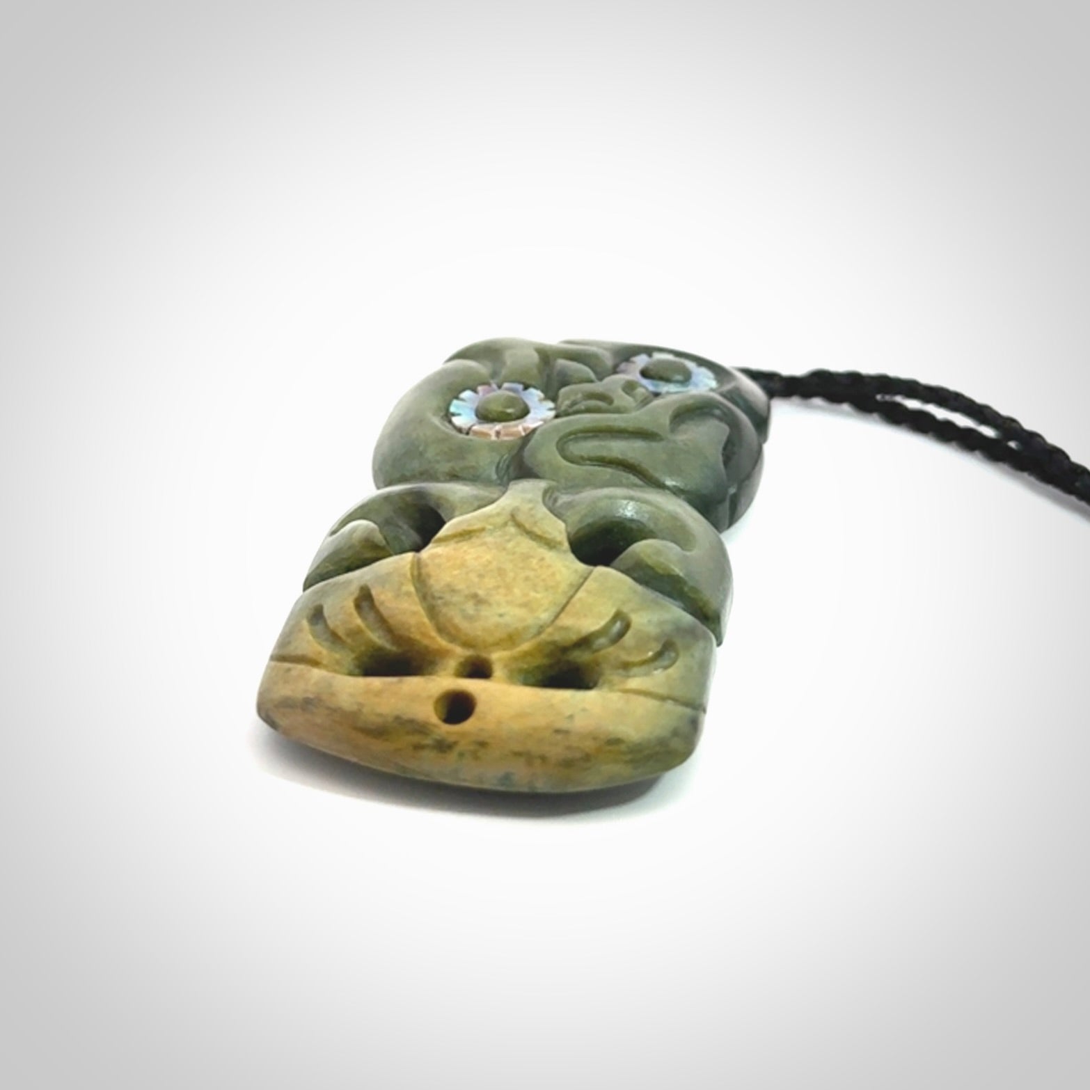 This is a medium sized tiki - carved from gorgeous New Zealand Marsden jade. The cord is an adjustable four plaited cord in black.