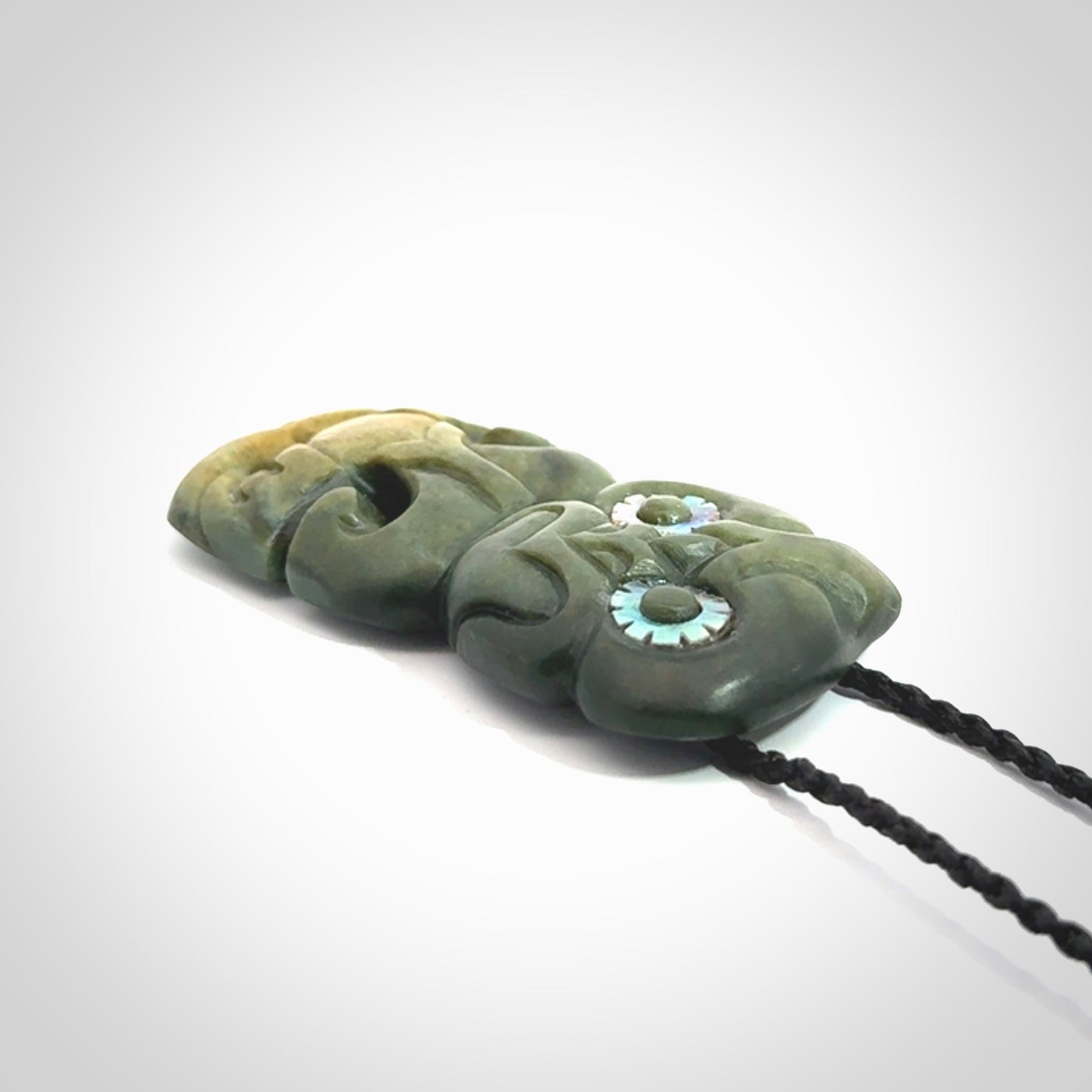 This is a medium sized tiki - carved from gorgeous New Zealand Marsden jade. The cord is an adjustable four plaited cord in black.