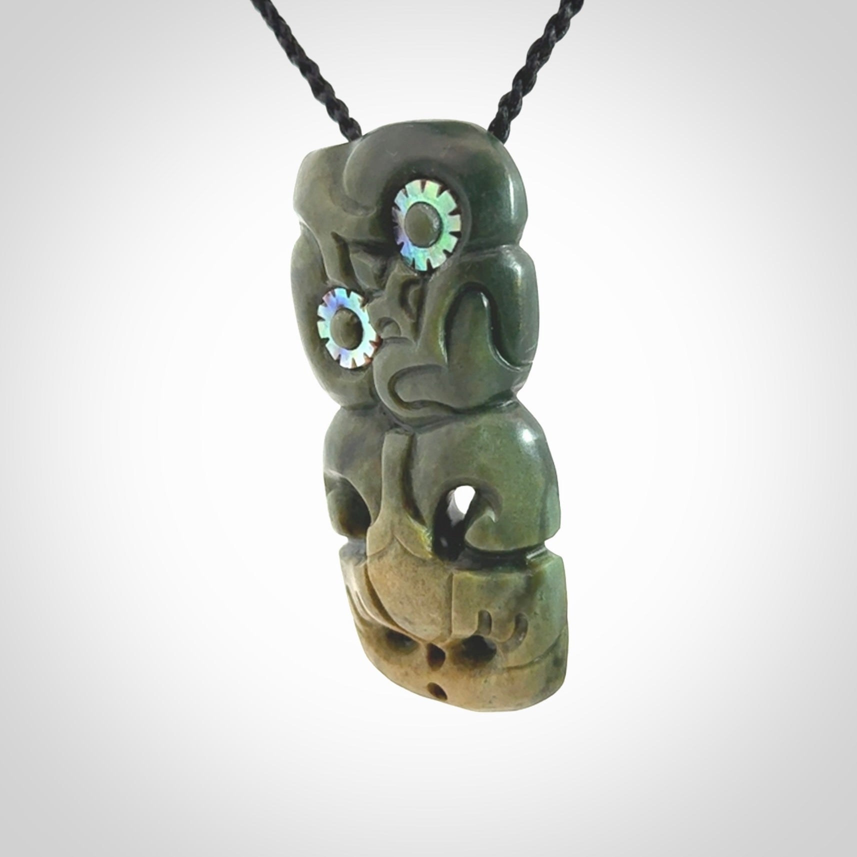 This is a medium sized tiki - carved from gorgeous New Zealand Marsden jade. The cord is an adjustable four plaited cord in black.