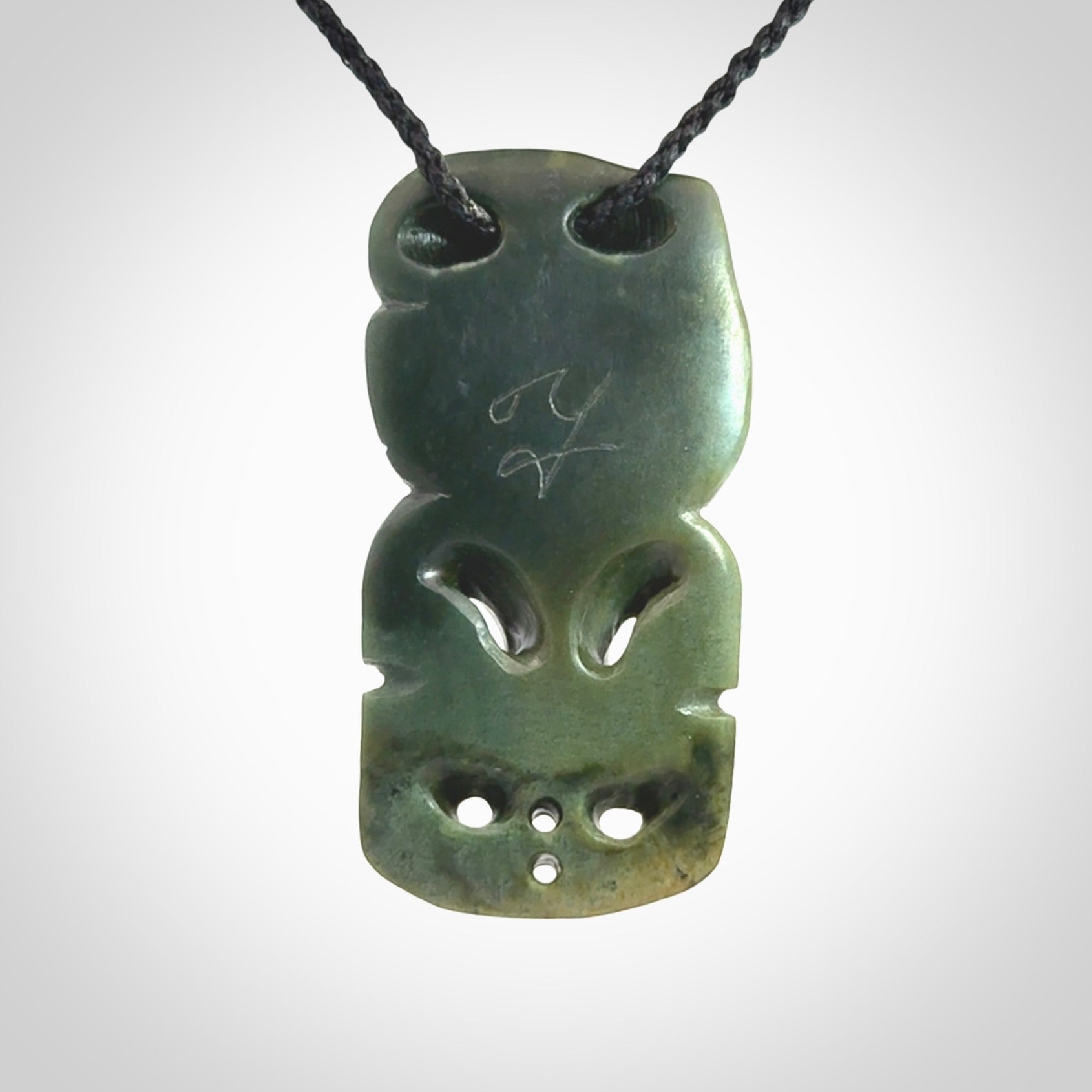 This is a medium sized tiki - carved from gorgeous New Zealand Marsden jade. The cord is an adjustable four plaited cord in black.