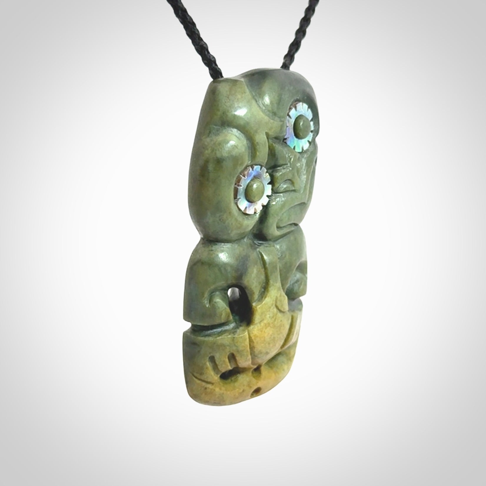 This is a medium sized tiki - carved from gorgeous New Zealand Marsden jade. The cord is an adjustable four plaited cord in black.