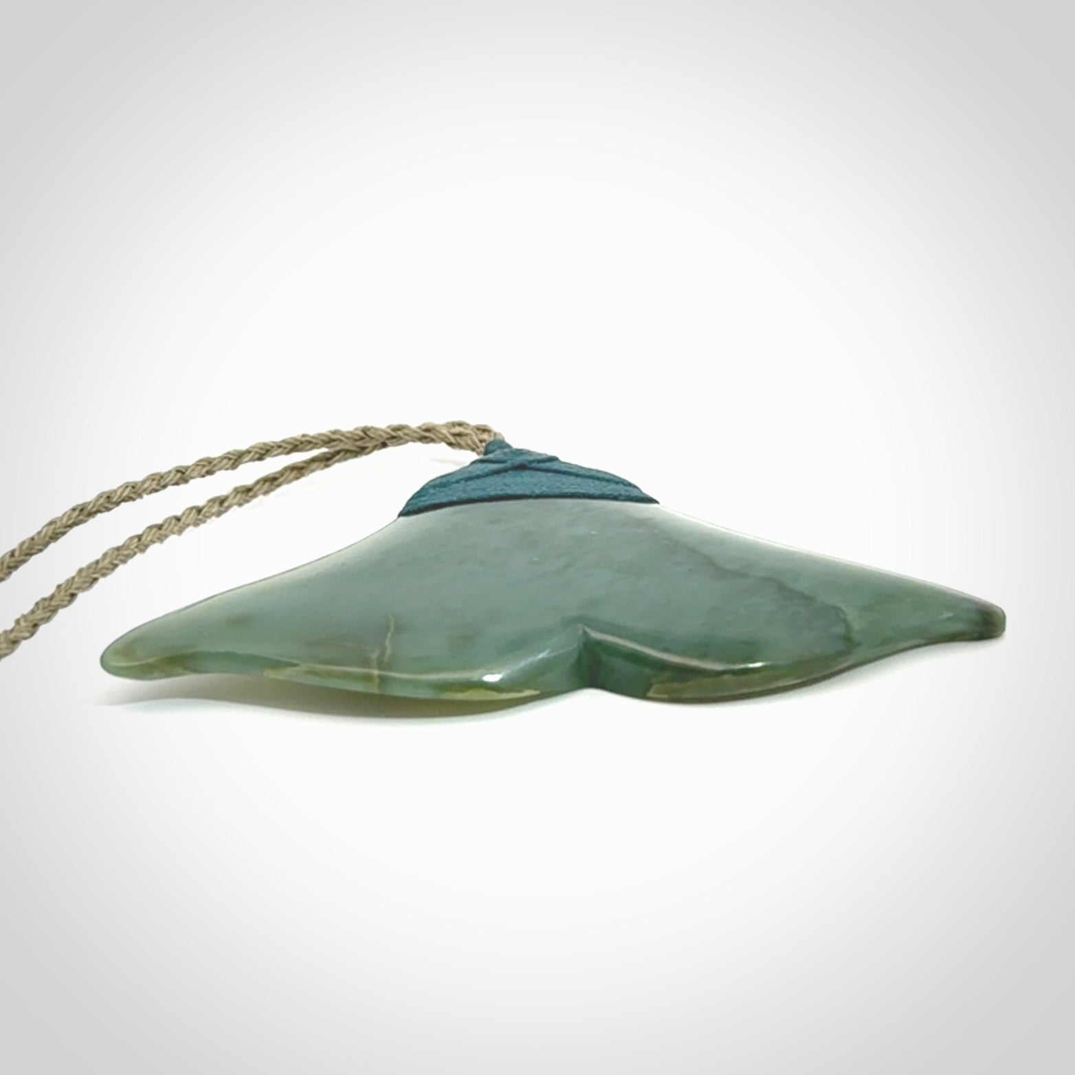 Hand carved New Zealand Jade whale tail pendant.
