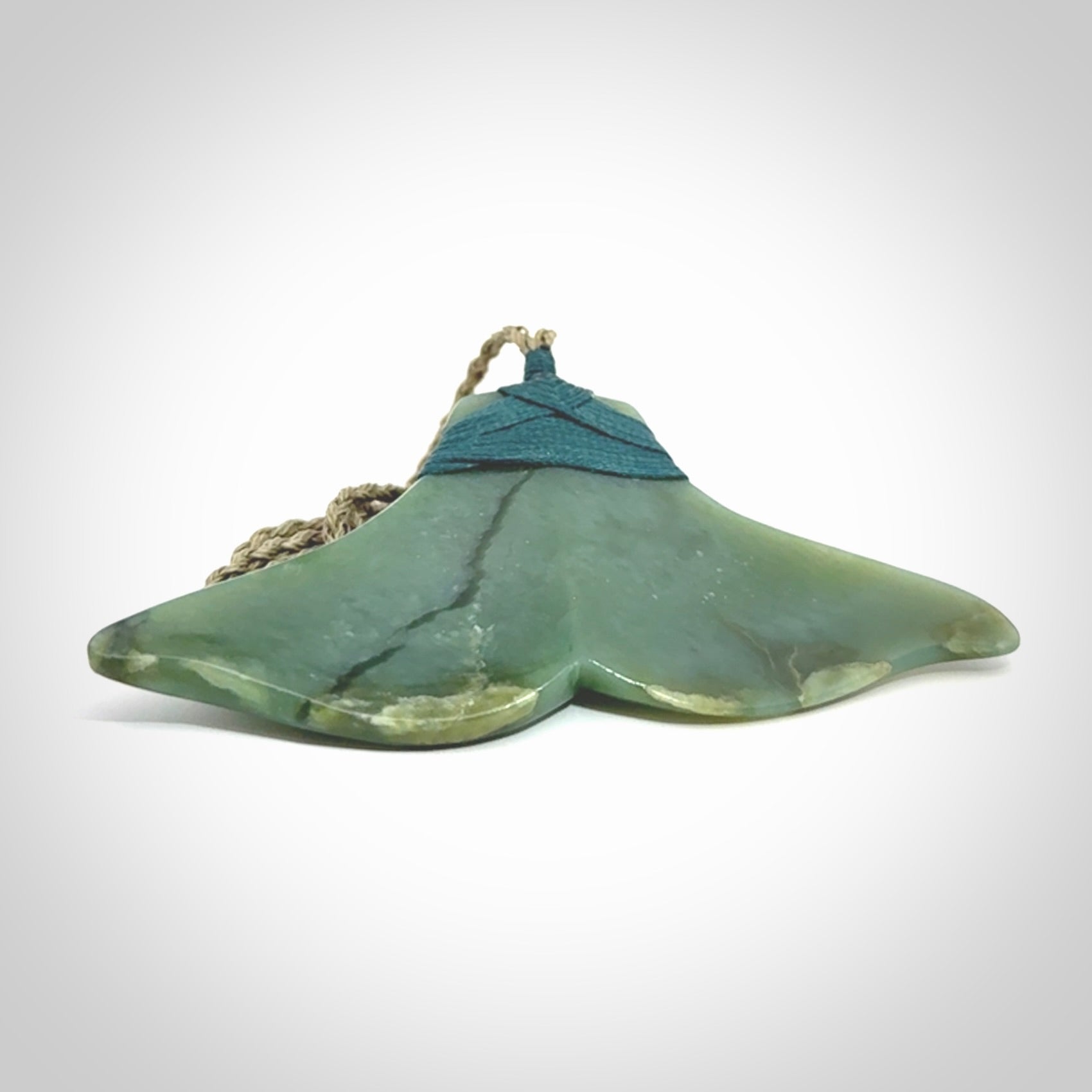 Hand carved New Zealand Jade whale tail pendant.