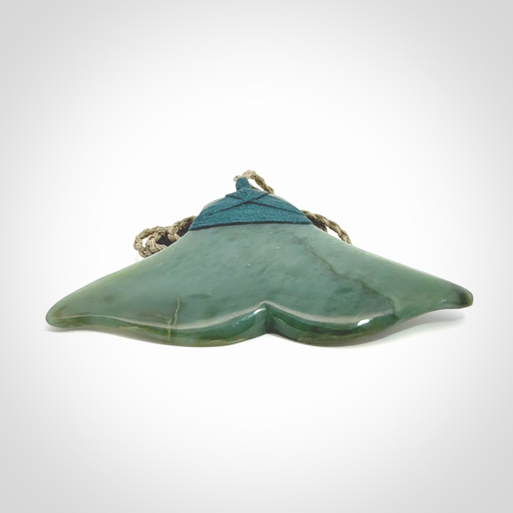 Hand carved New Zealand Jade whale tail pendant.