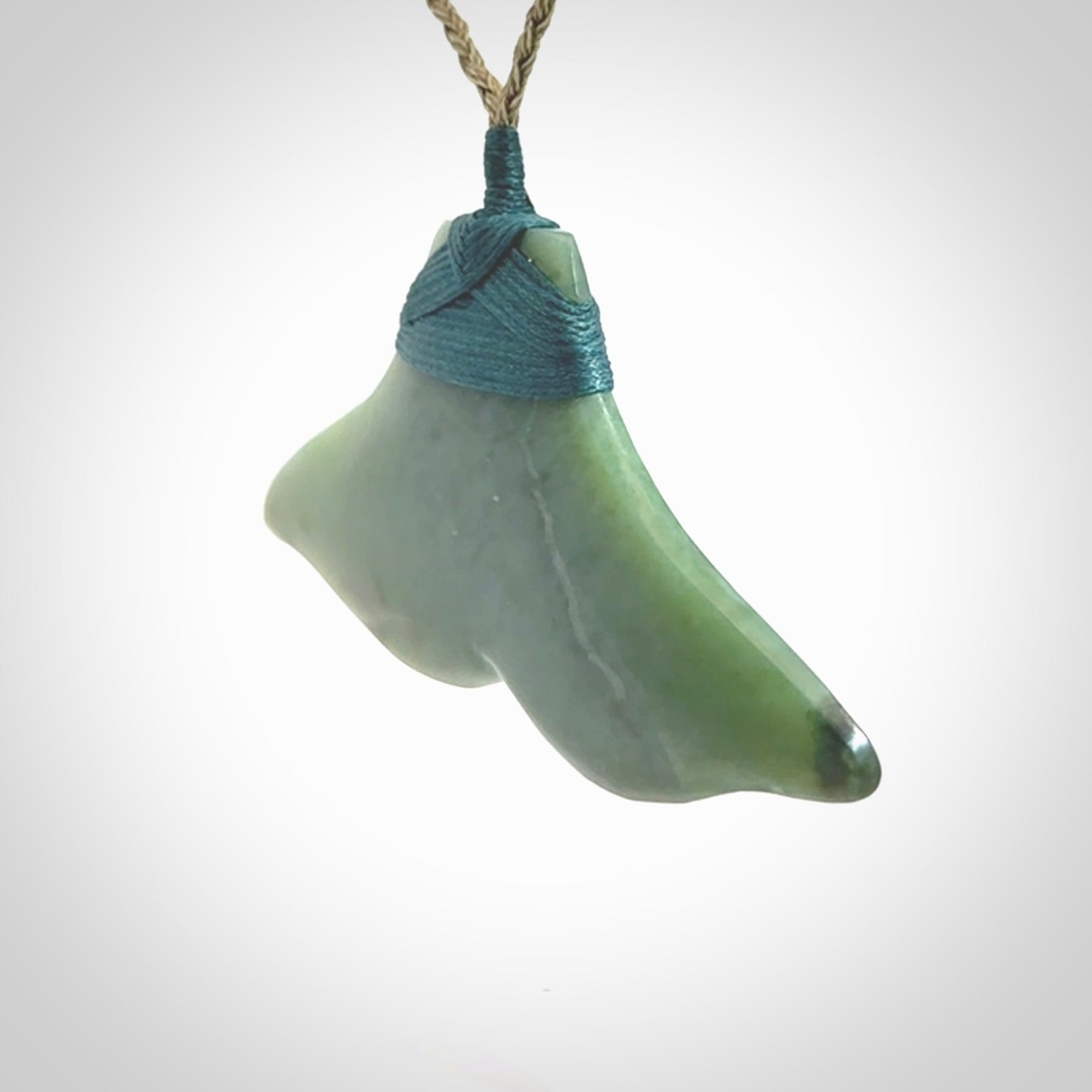 Hand carved New Zealand Jade whale tail pendant.