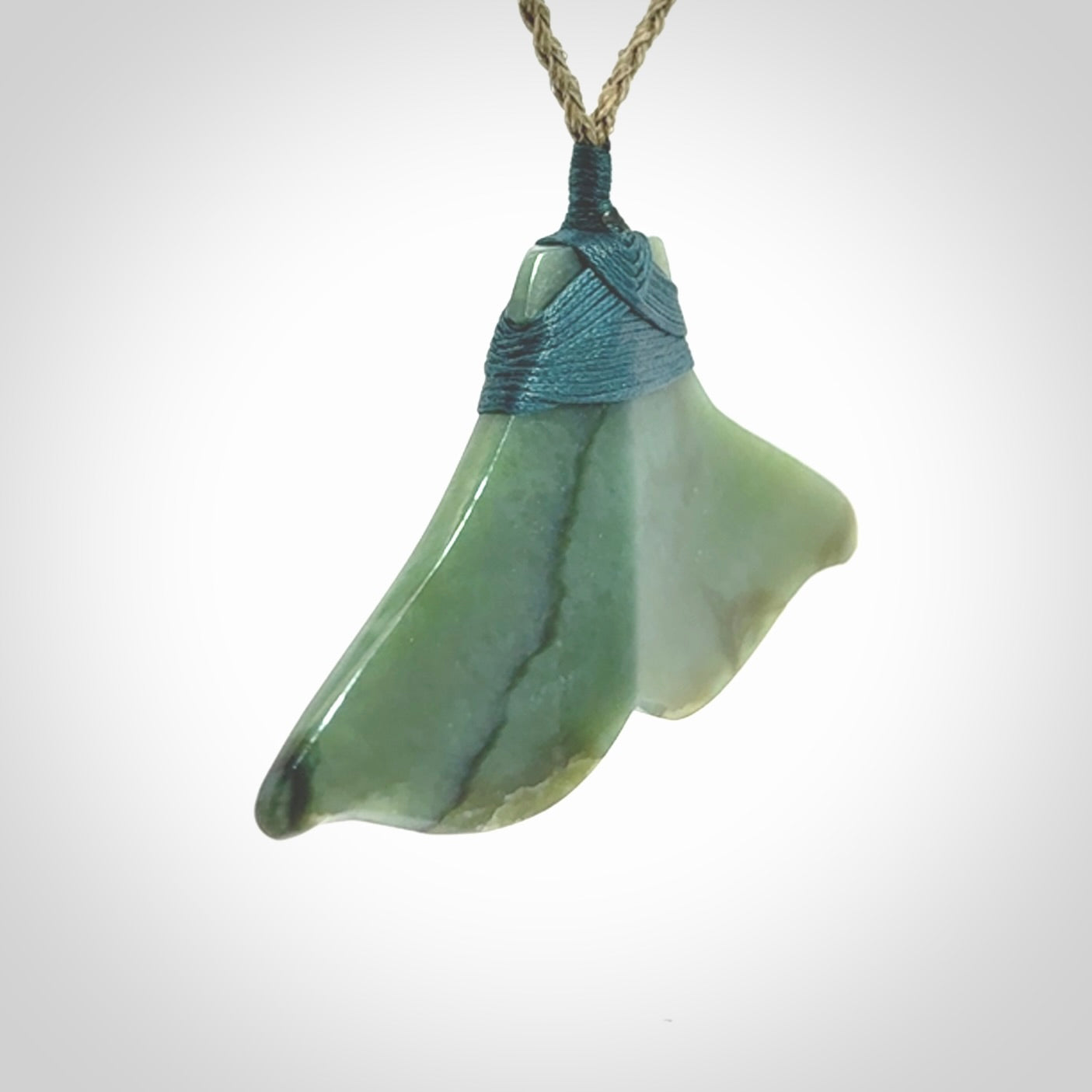Hand carved New Zealand Jade whale tail pendant.