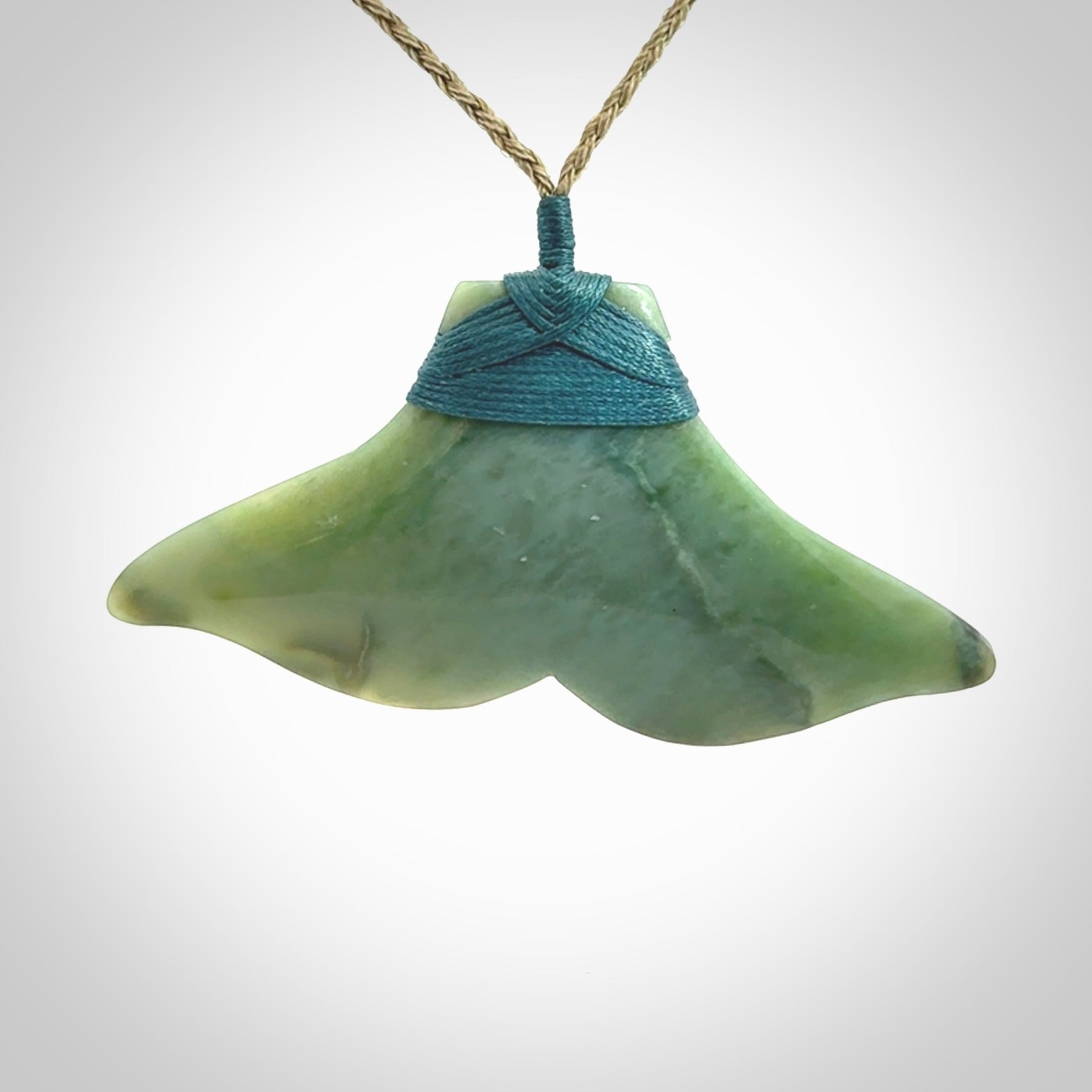 Hand carved New Zealand Jade whale tail pendant.