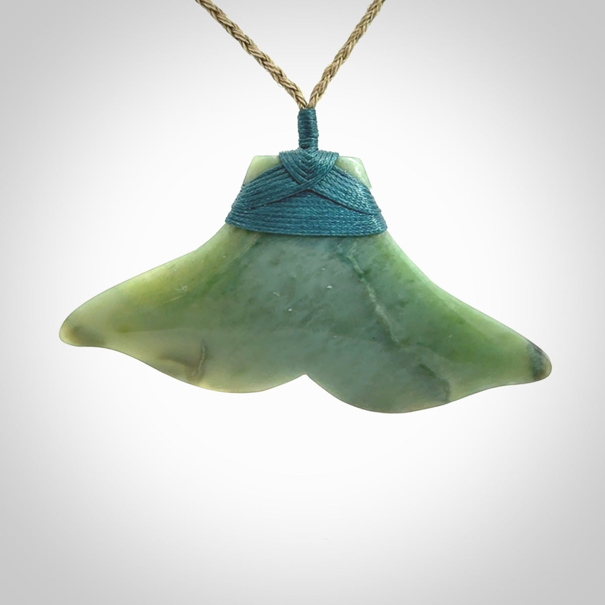 Hand carved New Zealand Jade whale tail pendant.