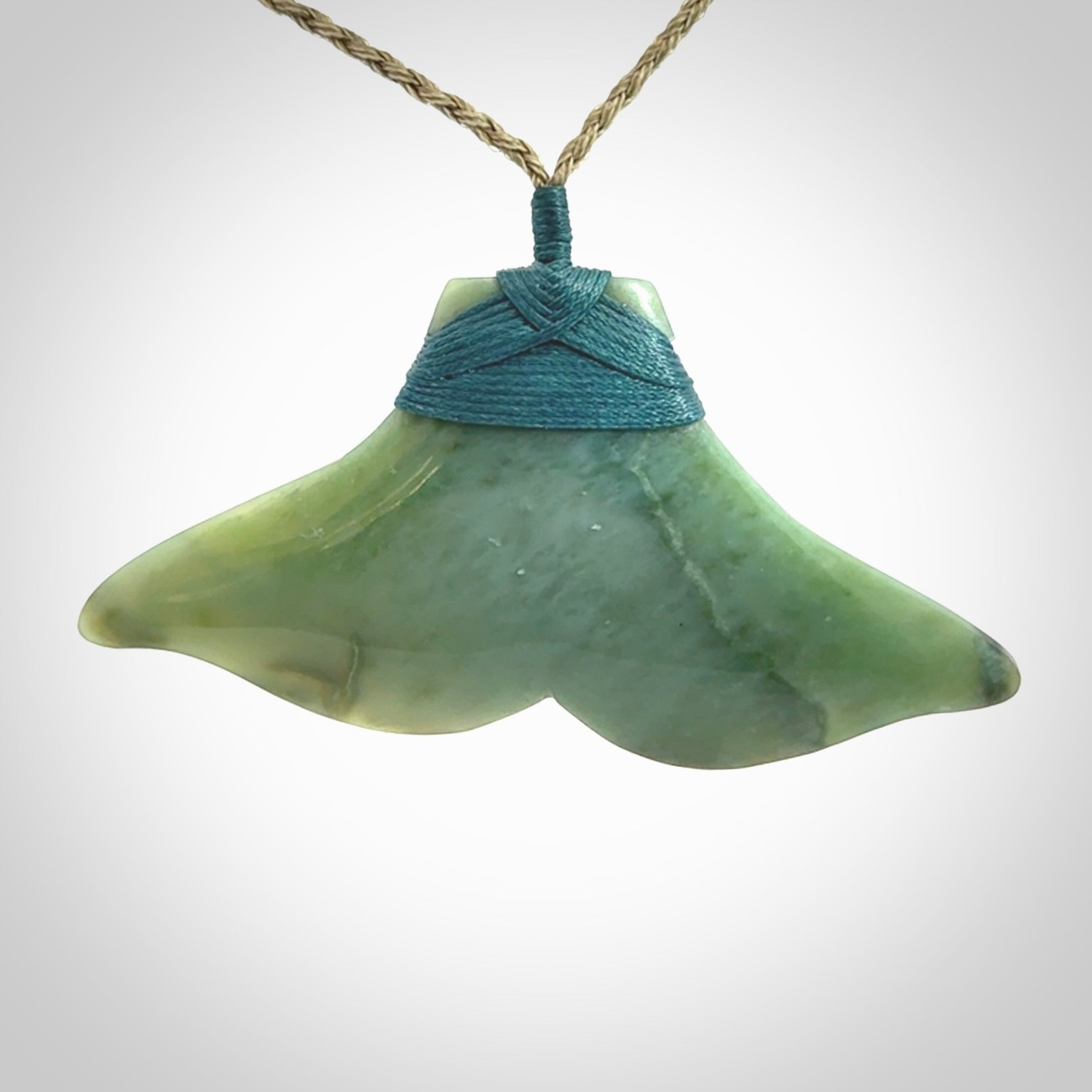 Hand carved New Zealand Jade whale tail pendant.