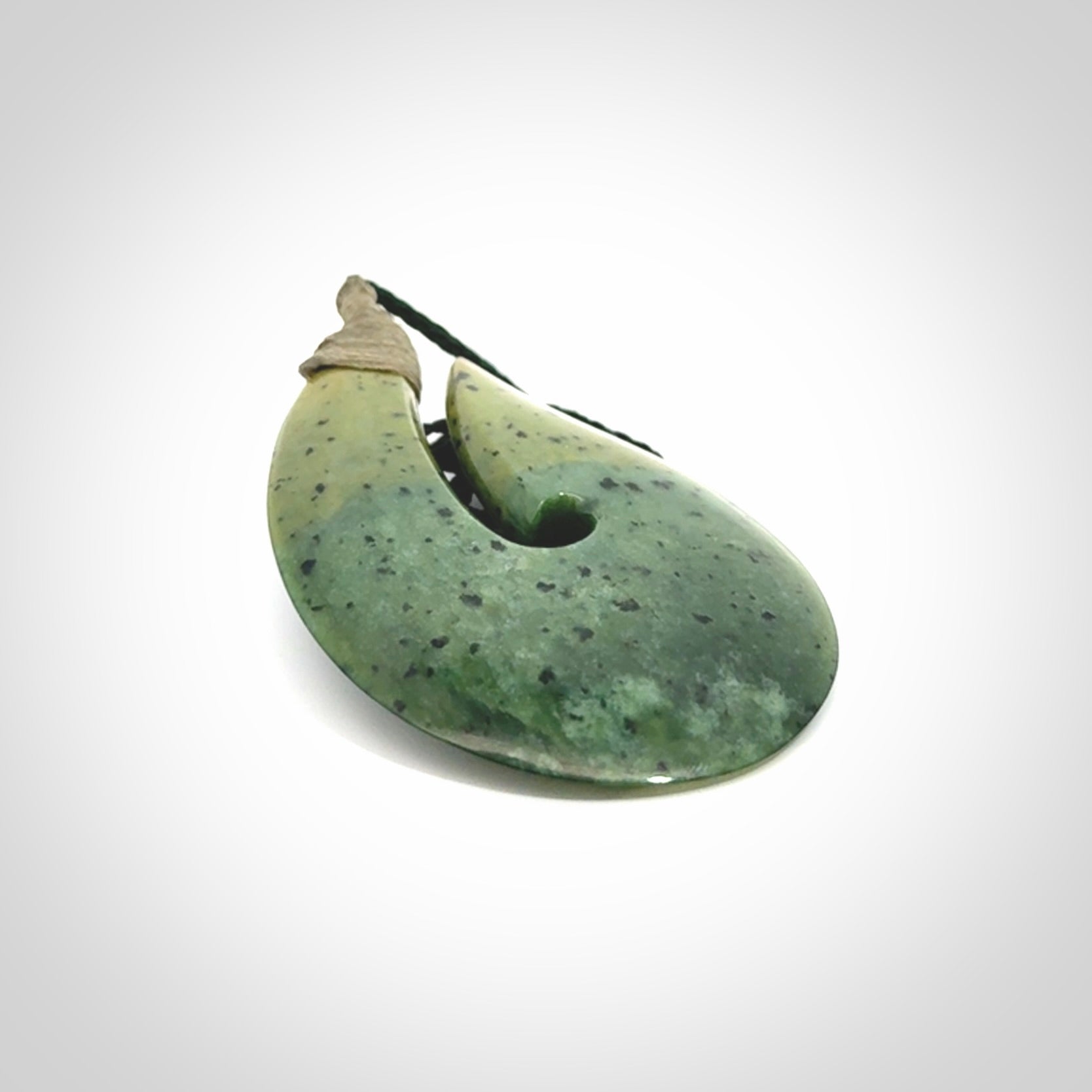 Hand carved New Zealand flower jade hook, matau pendant.