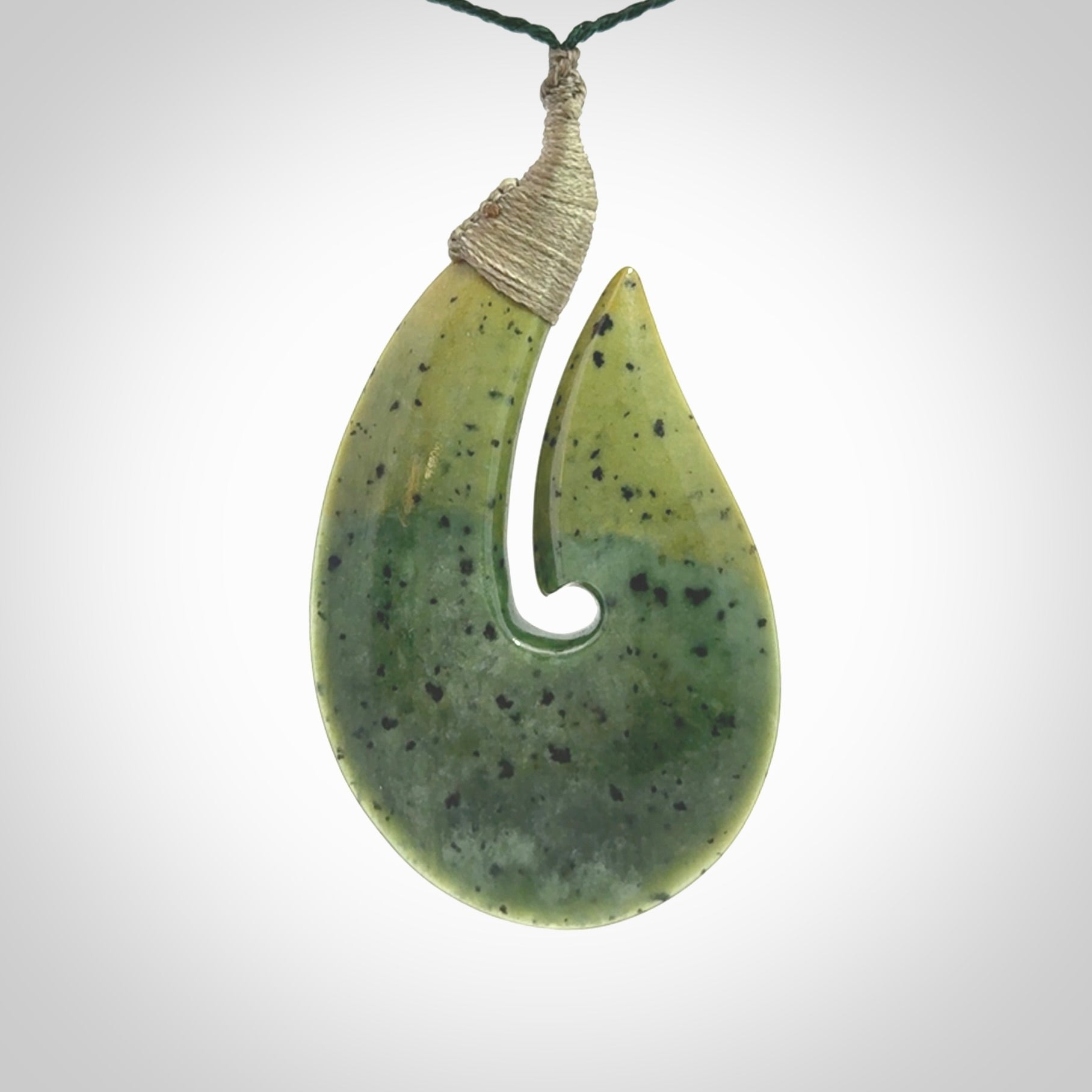Hand carved New Zealand flower jade hook, matau pendant.