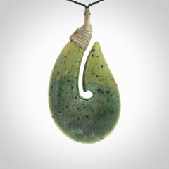 Hand carved New Zealand flower jade hook, matau pendant.