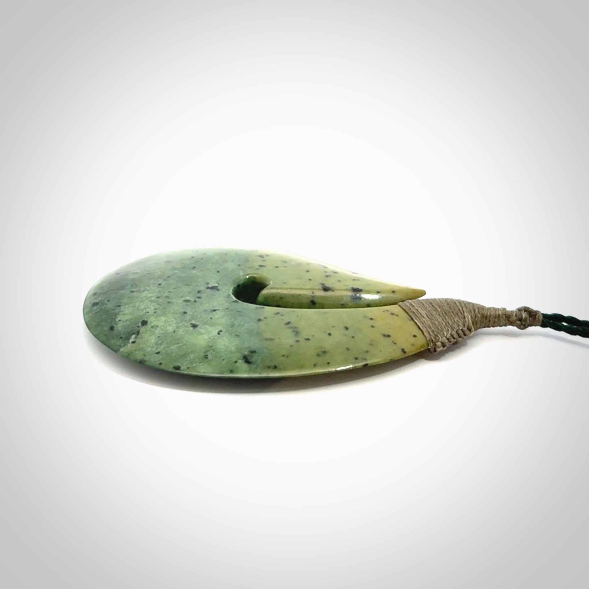Hand carved New Zealand flower jade hook, matau pendant.
