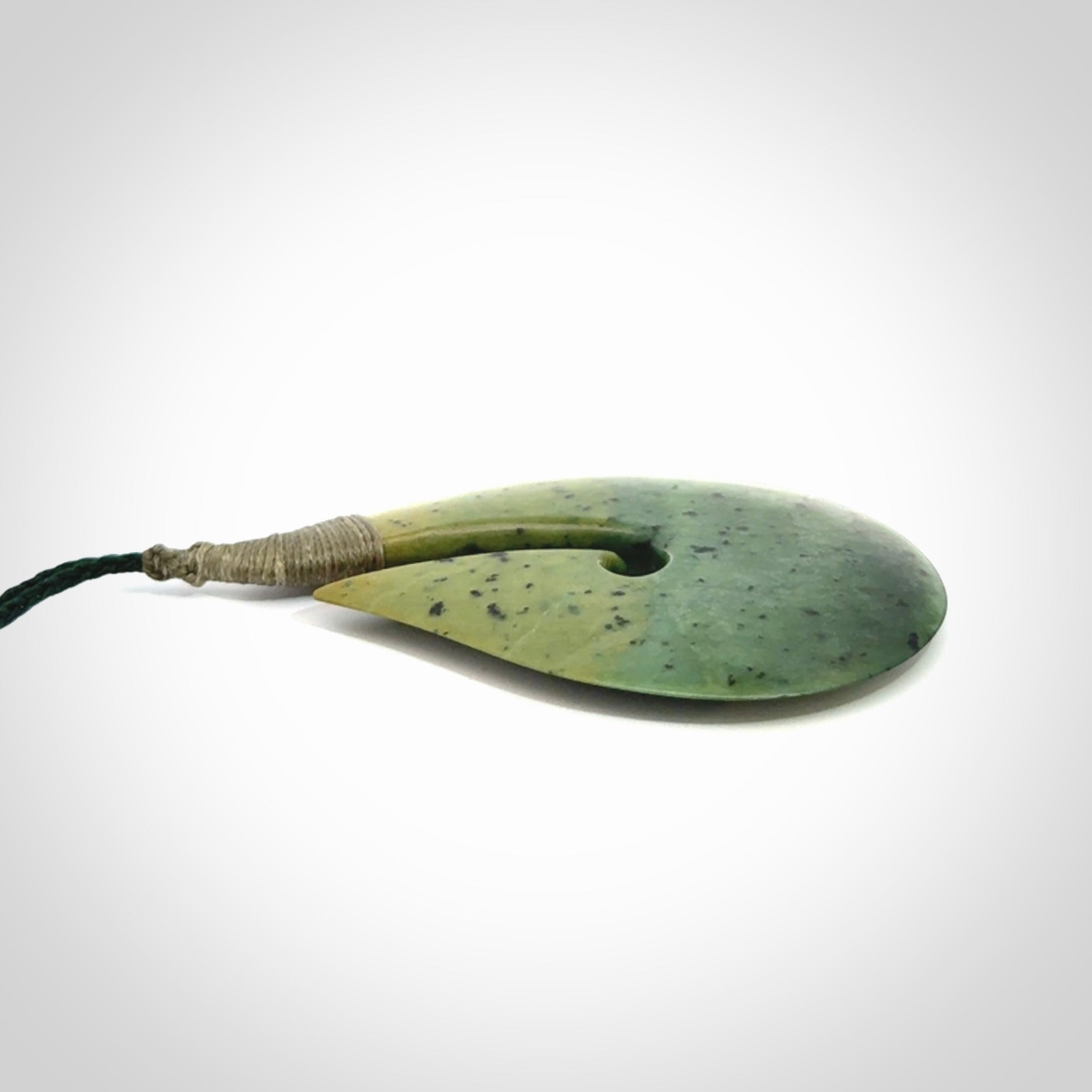 Hand carved New Zealand flower jade hook, matau pendant.