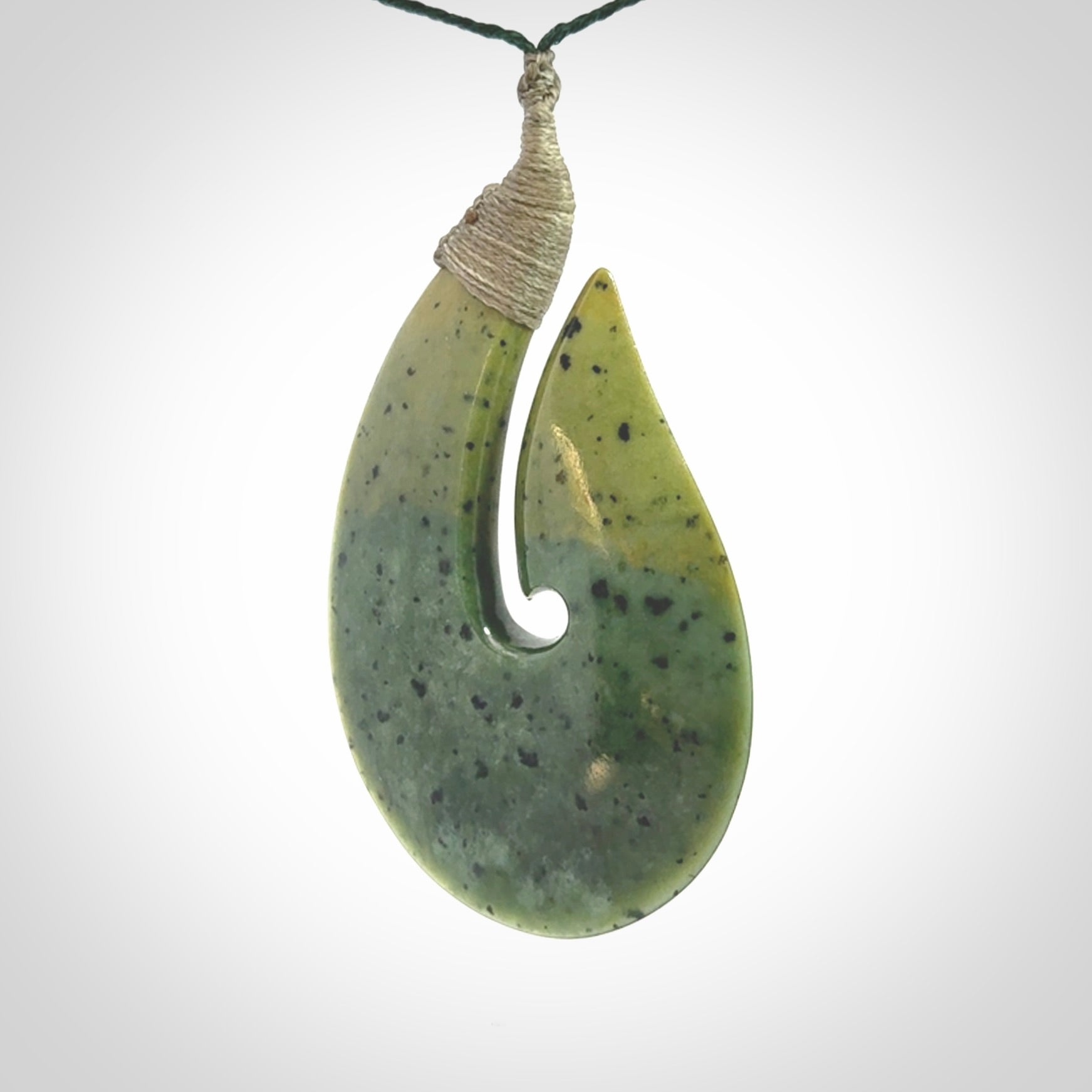 Hand carved New Zealand flower jade hook, matau pendant.