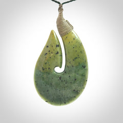 Hand carved New Zealand flower jade hook, matau pendant.