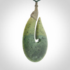 Hand carved New Zealand flower jade hook, matau pendant.