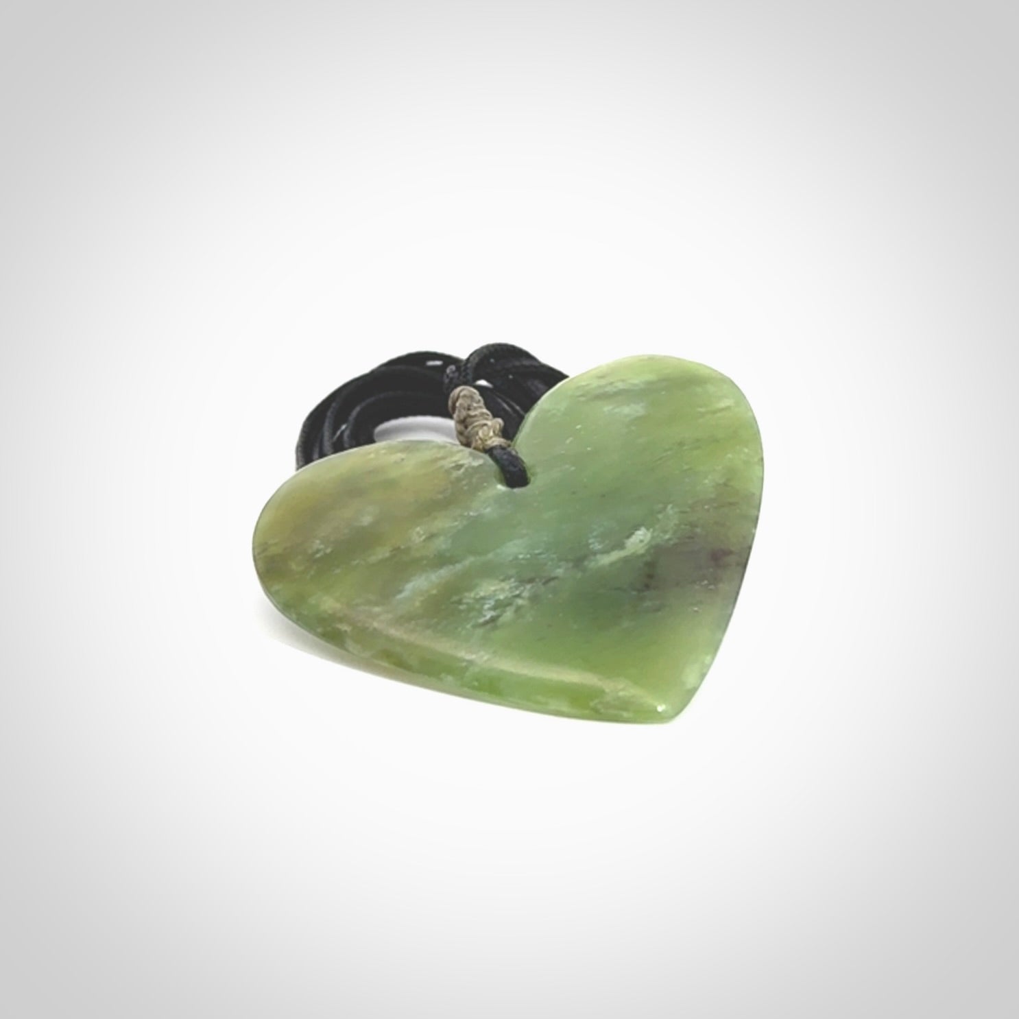 A hand carved heart pendant made from New Zealand jade.
