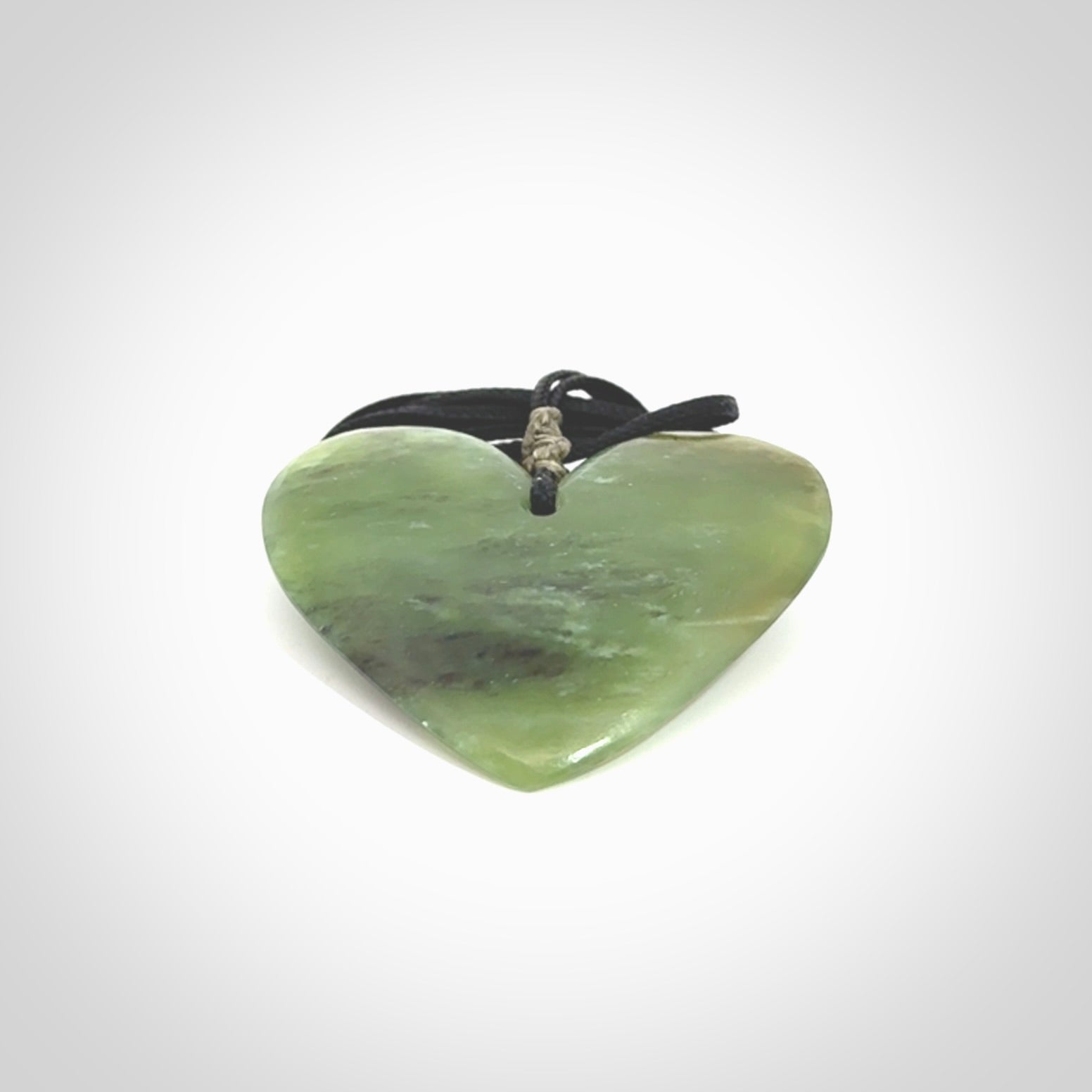 A hand carved heart pendant made from New Zealand jade.