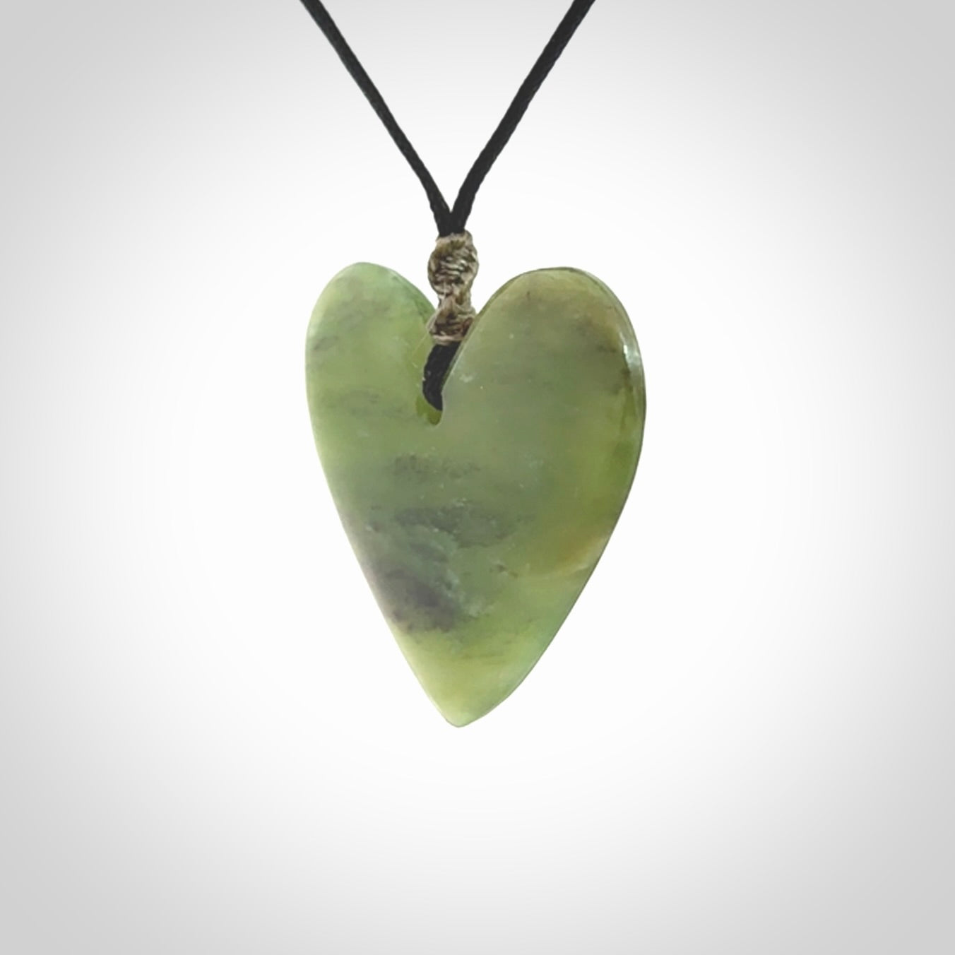 A hand carved heart pendant made from New Zealand jade.